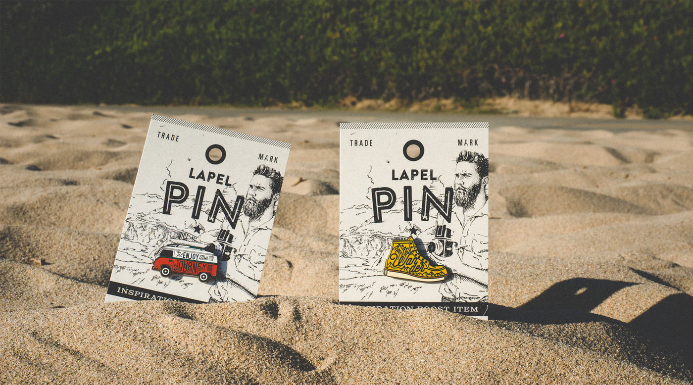 lapel pins in the sand - decorative cover for FAQ page